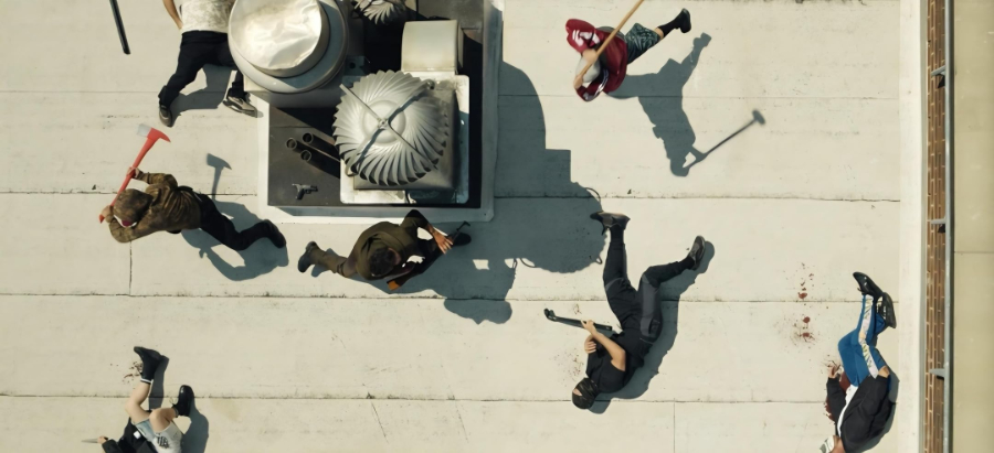 Action shot from The Punisher: One Last Kill. Seen from overhead, a number of men with axes and bats either lay dead on the floor or attempt to strike Frank Castle, standing in the center of the action.